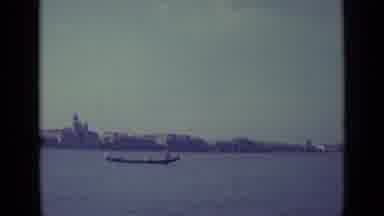 Venice Italy (1962): Two Boats Pass By City Skyline Serene Lake Daytime Travel