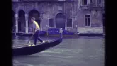Venice Italy (1962): Man Rowing Gondola Boat On River With People In Boat Wearing