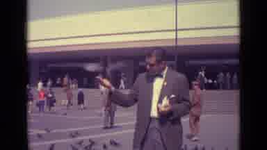 Venice Italy (1962): Men Play And Feed Pigeons In An Outdoor Supermarket Area