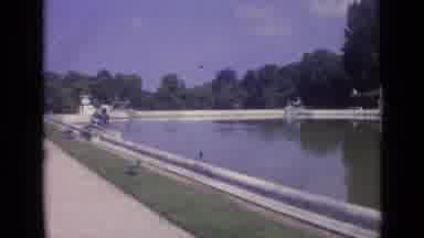 Versailles France-1962: A Grand Pond And Palace With Tourists Walking By