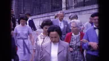 Versailles France (1962): Excited Group Of People Walks On Big City Sidewalk