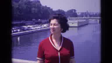 Versailles France (1962): A Woman Dressed In Red Stands On A Bridge Over A River