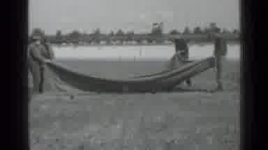 Saint Petersburg Russia (1967): Four Men Shaking Out Blanket In Old Footage On