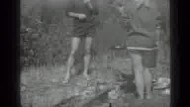 Saint Petersburg Russia (1967): Woman Wearing Grey Dress Places Pan Of Food On