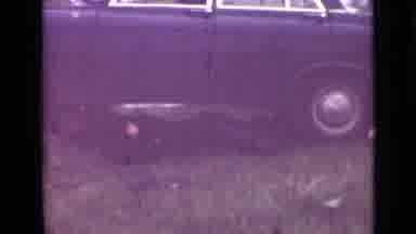 Saint Petersburg Russia (1967): Man Works To Repair His Vehicle On The Side Of The