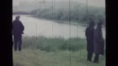 SAINT PETERSBURG RUSSIA-1967: Men And Women Near A Lake Possibly Searching