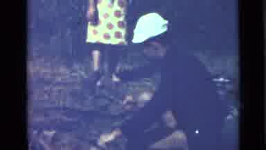 Saint Petersburg Russia (1967): Young Man Uses Short Ax To Chop Branch As Woman