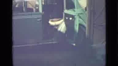 Saint Petersburg Russia (1967): Woman Wearing Red Dress Loads Items Into Blue Van