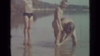 Saint Petersburg Russia (1967): Mother Cleans Off Boy's Leg In The Water As He