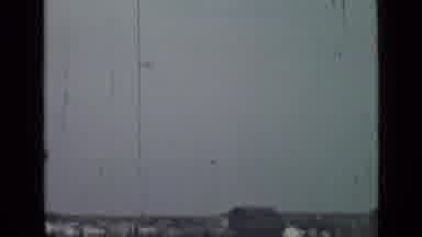 Saint Petersburg Russia (1967): Airplane Flying Through Cloudy Skies Over A Town