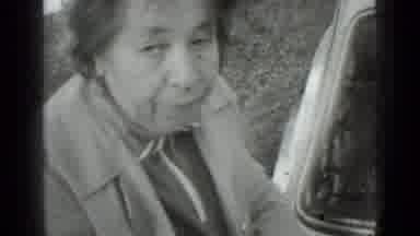 Moscow Russia (1975): Woman Wearing Grey Coat Scrapes Ground With Garden Hoe On A