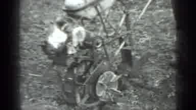 Moscow Russia (1975): A Man Standing With A Grass Cutter Like Machine And Watching