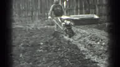 Moscow Russia (1975): Man Pulls Gas Powered Tiller From Stuck Position And Resumes