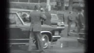 Moscow Russia (1983): Man Wearing Grey Suit Walks Past Car In Parking Lot On A