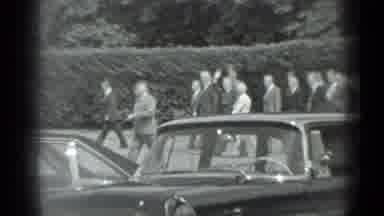 Moscow Russia (1983): Entourage Waves As They Walk Past Hedge And Cars On A Sunny