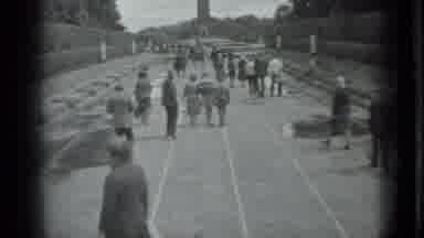 Moscow Russia (1983): People Walking On A Street With Plants On The Sides And A