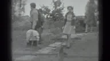 MOSCOW RUSSIA-1983: A Young Girl And Boy Are Walking Down A Stone Path Towards A