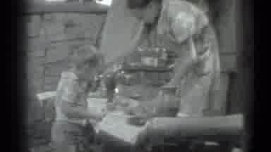Moscow Russia (1983): Woman Prepares Meal For Boy Outside Her Home On Sunny Day