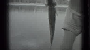 Moscow Russia (1983): A Man In A Fishing Hat Pulls A Fish Out Of A Lake