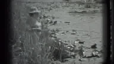 Moscow Russia (1983): A Person Standing At The Edge Of A Lagoon Fishing