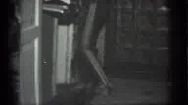 MOSCOW RUSSIA-1983: Woman Walking Into A Room Carrying A Beverage With Striped Pants