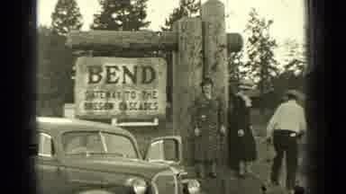 Bend Oregon (1937): People Standing Near An Engraved Stone Reading The History