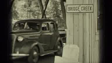 Bend Oregon (1937): A Car Driving On A Road Way Enjoying A Nice Day Out