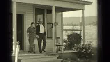Bend Oregon (1937): Man And Woman Exit Home Together And Walk Closely In Unison
