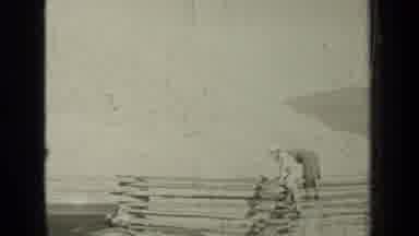 Bend Oregon (1937): Two People Climb A Large Piece Of Wood Near A Truck On A Farm