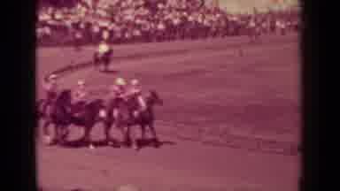 Klamath California (1937): Horses And Riders Galloping Around A Race Track While