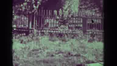 Medford Oregon (1937): Three Older Adults Walking Outdoors Through A Fenced In