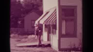 Medford Oregon (1937): A Man In A Suit And Hat Walks Out Of Store With An Awning