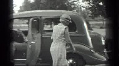Long Lake Canada (1939): A Woman Walking Around A Car Cuts To A Couple In A Car