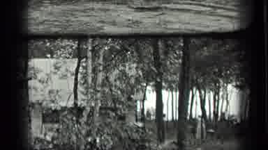 Long Lake Canada (1939): Old Home In The Forest With Woman In Back Of Tree In A