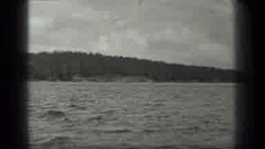 Long Lake Canada (1939): Boat On A Calm Overcast Day Onlooking A Wooded Shoreline