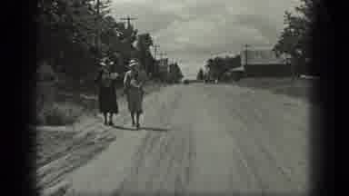 Long Lake Canada (1939): Two Women Walk Down Dirt Road Carrying Packages On A