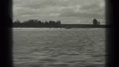 Long Lake Canada (1939): A Speedboat Speeding Through The Waters Next To A Forest