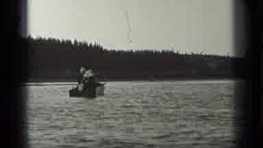 Long Lake Canada (1939): Two People Fish In A Boat In Calm Waters