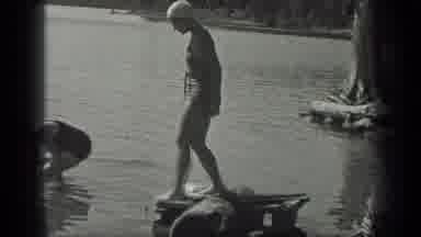 Long Lake Canada (1939): Two Young Women Enjoy Swimming Near The Shore During A