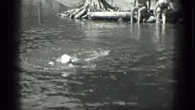 Long Lake Canada (1939): A Woman Swimming Sideways In A Lake With Two More People