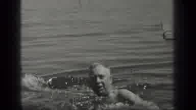Long Lake Canada (1939): Older Man Swimming In A Lake As A Small Dock Floats In