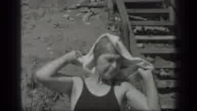 Long Lake Canada (1939): Smiling Man In Water Looks Up Towards Woman Toweling Off