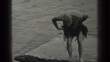 Long Lake Canada (1939): Man Using Seaweed From The Ground To Create A Grass Skirt