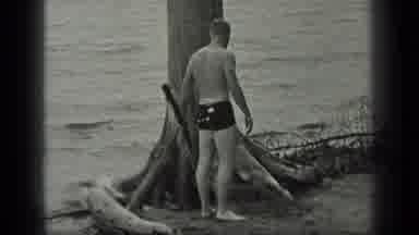 Long Lake Canada (1939): Black And White Video Of A Man Standing Behind A Large