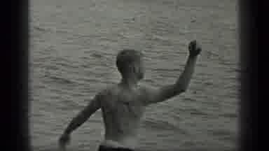 Long Lake Canada (1939): A Man In A Bathing Suit Performing Actions Next To A Body