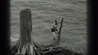 Long Lake Canada (1939): Man Lifts Log Out Of River
