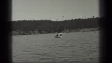 Long Lake Canada (1939): Smiling Man In A Bathing Suit Sailing On A Large