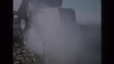 Minnesota USA (1958): Harvester Gathering Grain In Field And Augering It Into