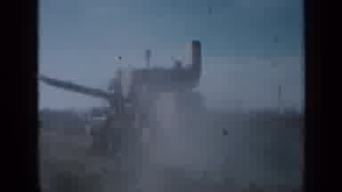 Minnesota USA (1958): Big Tractor Tending Overgrown Widespread Crops Huge Field