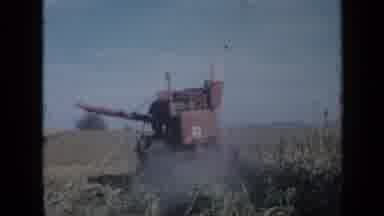 Minnesota USA (1958): Red Thresher Moves Away And Then Returns As It Cuts Crops